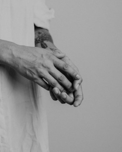 A black and white photo of a person's hands with intricate tattoos is the perfect way to capture the essence of Vayu Retreat Villas, a boutique hotel in Costa Rica that offers an all-inclusive, holistic wellness experience. The hands are relaxed and held together, suggesting a sense of peace and tranquility. The tattoos are detailed, reflecting the vibrancy of the Costa Rican rainforest. The photo is a reminder that Vayu Retreat Villas is the perfect place to escape from the stresses of everyday life and reconnect with yourself.