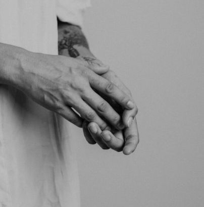 A black and white photo of a person's hands with intricate tattoos is the perfect way to capture the essence of Vayu Retreat Villas, a boutique hotel in Costa Rica that offers an all-inclusive, holistic wellness experience. The hands are relaxed and held together, suggesting a sense of peace and tranquility. The tattoos are detailed, reflecting the vibrancy of the Costa Rican rainforest. The photo is a reminder that Vayu Retreat Villas is the perfect place to escape from the stresses of everyday life and reconnect with yourself.