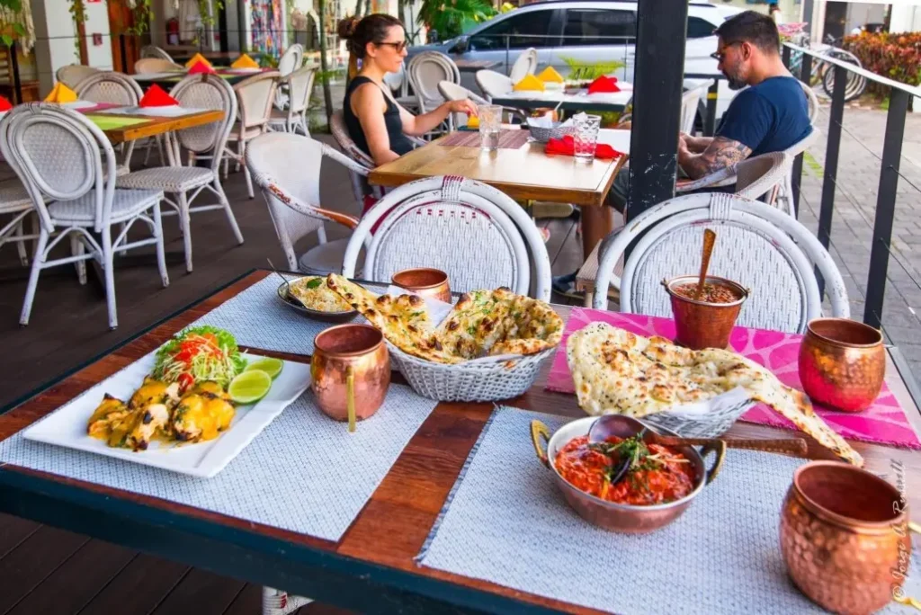 Outdoor dining setup with Indian dishes at Hola India, a popular spot among Uvita restaurants in Costa Rica and a nice place to visit when staying at Vayu Retreat Villas 