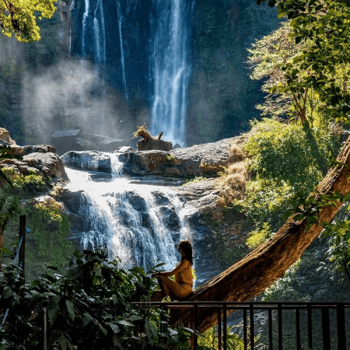 visit beautiful nauyaca waterfalls like this woman seen overlooking the cascades