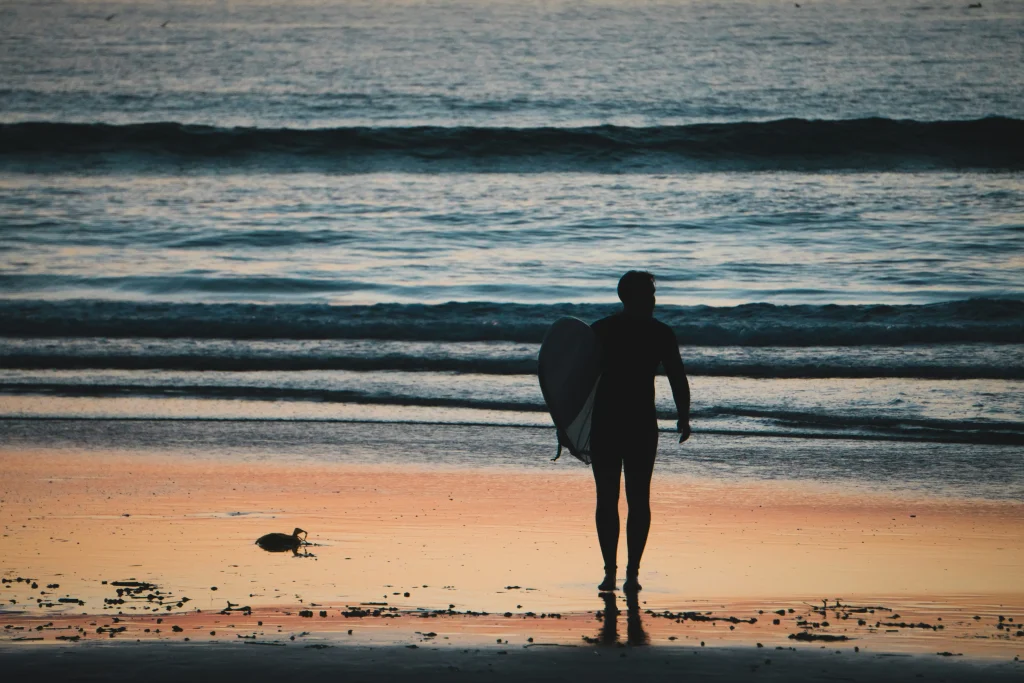 A solitary figure on a serene beach in Costa Rica at sunset close to Vayu Retreat Villas in Uvita