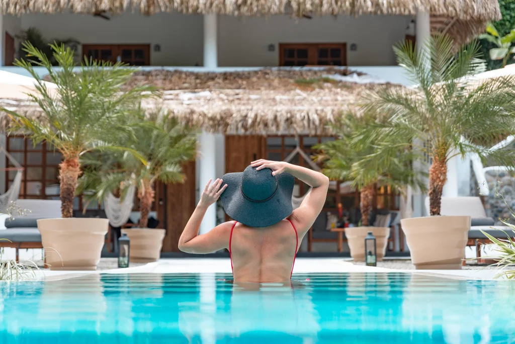 Woman relaxing in a pool at a jungle hotel in Costa Rica, enjoying December in Costa Rica's warm weather at Vayu Retreat Villas.