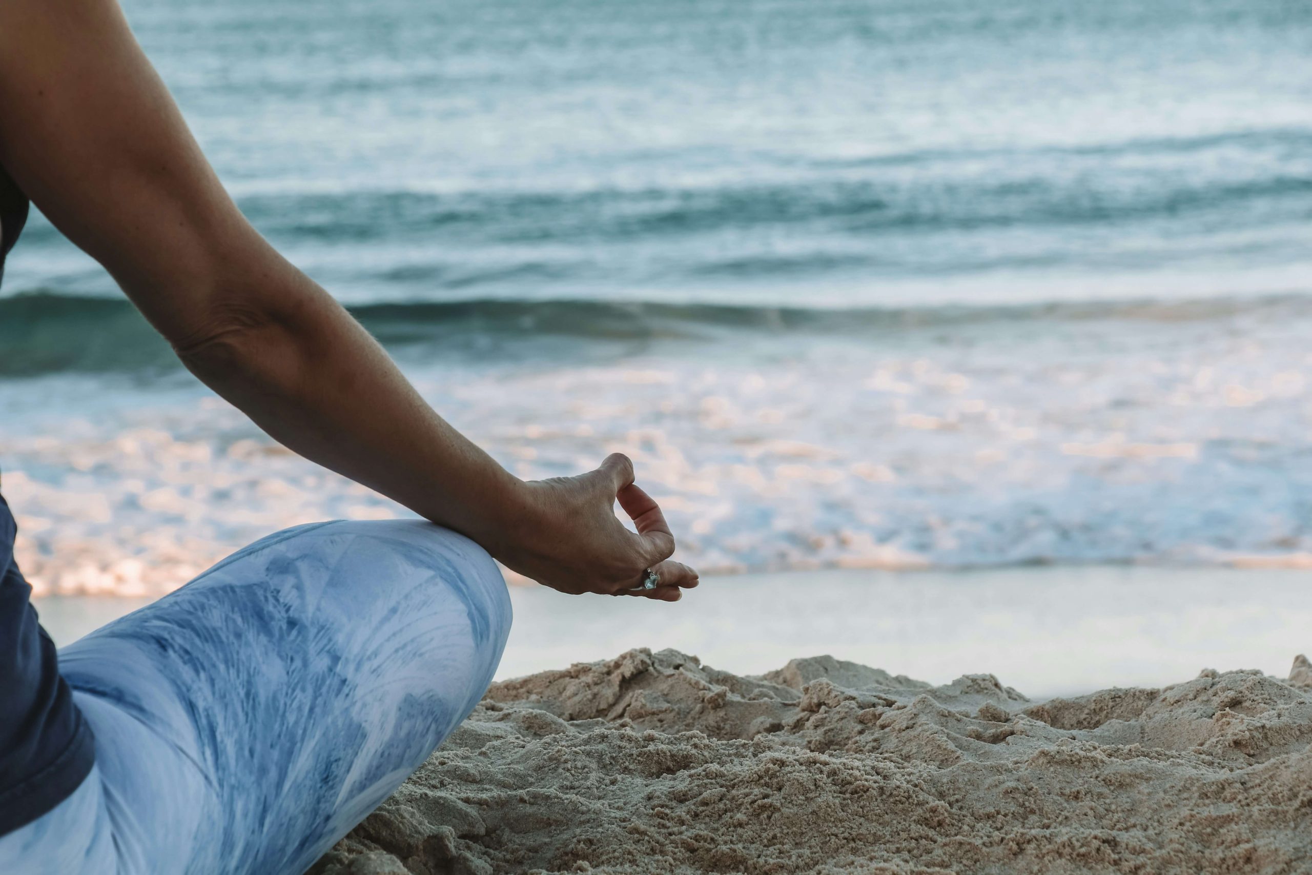 Close-up of a person meditating on the beach, showcasing mindfulness practices at Vayu Retreat Villa in Costa Rica.