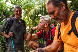 3 men Hiking through the lush rainforest of Corcovado National Park in Costa Rica, a popular activity during December in Costa Rica.