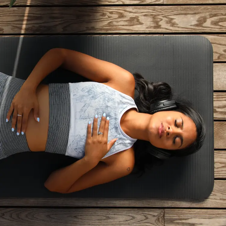 Woman meditating with headphones at Vayu Retreat Villas, a top Costa Rica Wellness Resort.